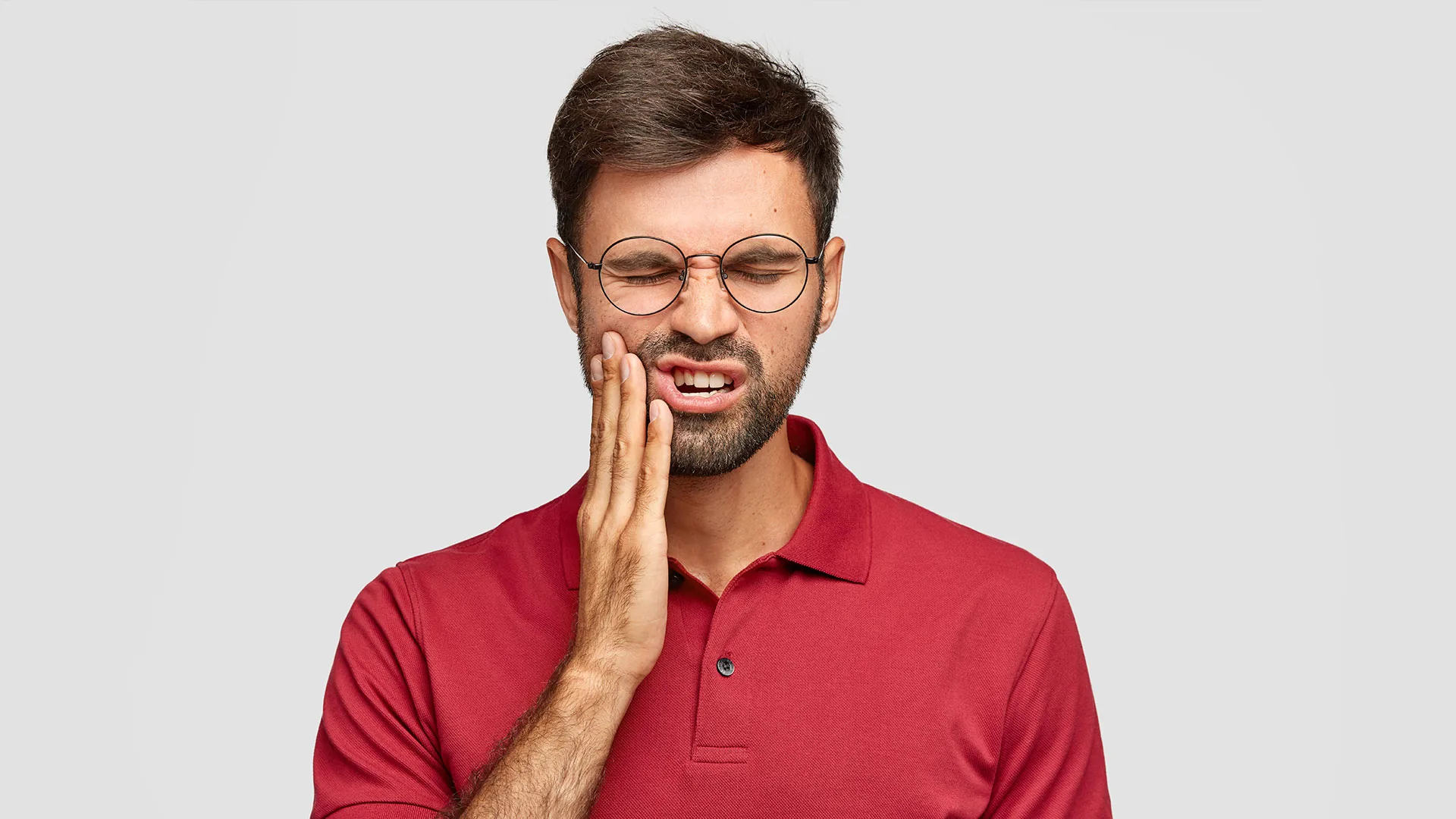 Patient experiencing dental pain — Reform Dentistry emergency care