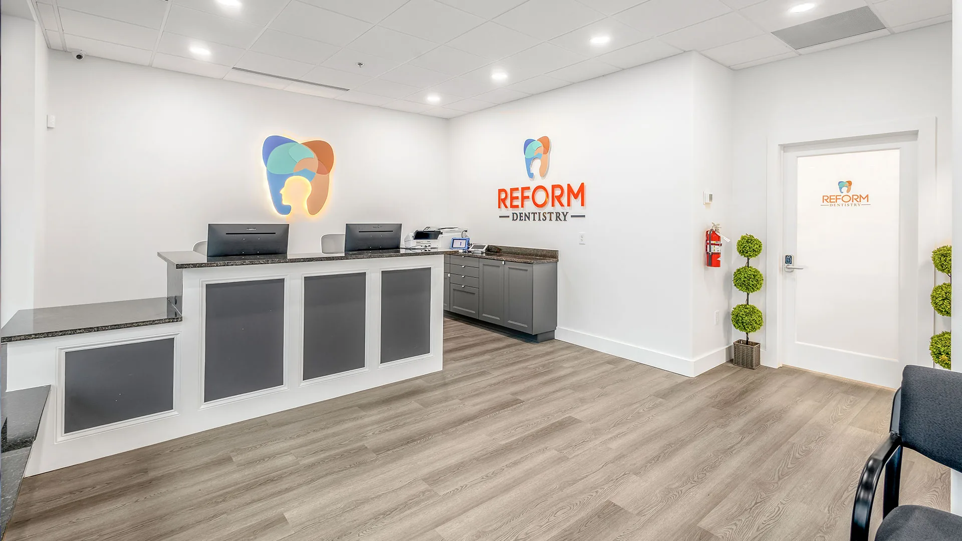 Reform Dentistry reception area with the practice logo